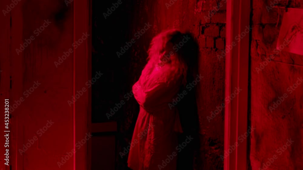 Crazy tied up woman standing by the wall and shaking and getting attacked by a man Crazy tied up woman standing by the wall and shaking and getting attacked by a man