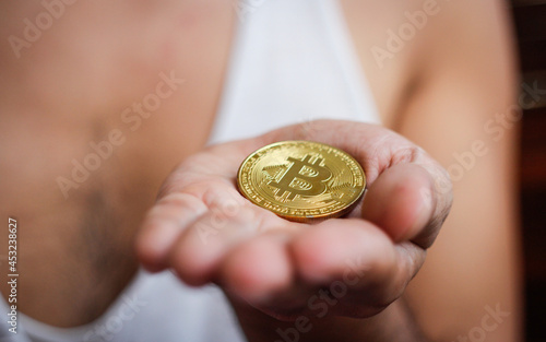  Gold Bitcoin cryptocurrency in hand, blockchain technology decentralized currency coin