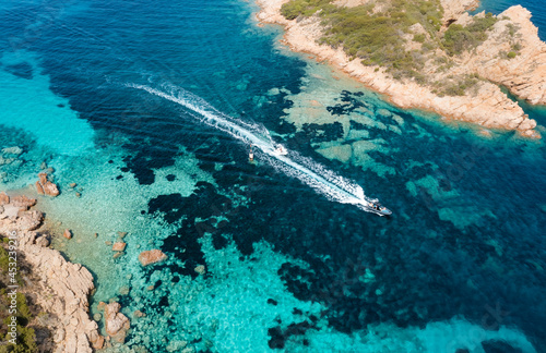 View from above, stunning aerial view of some boats sailing on a crystal clear, turquoise water. Giardinelli island, La Maddalena Archipelago, Sardinia, Italy.