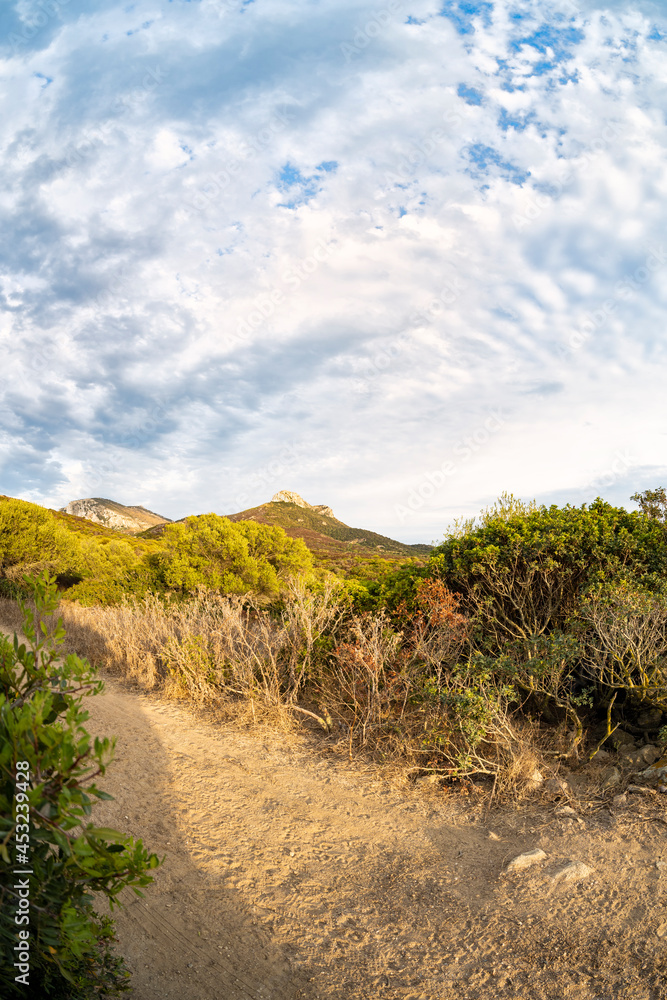 Stunning view a trail leading to Capo Figari. Capo Figari is a limestone promontory located in Gallura, in the north-east of Sardinia, in the municipality of Golfo Aranci, Italy.