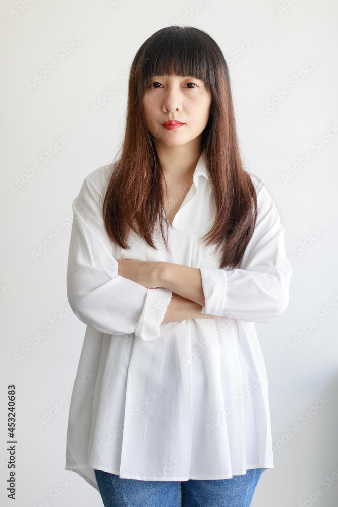 Portrait of elderly good looking beautiful fair hair Asian woman with a little smiling calm face, looking with satisfaction and self-confident at the camera. Portrait of elderly good looking beautiful fair hair Asian woman with a little smiling calm face, looking with satisfaction and self-confident at the camera.