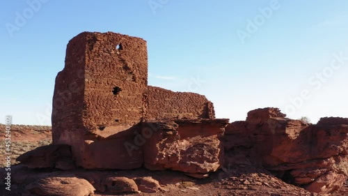 Parallax shot with Wokuki Pueblo ruins. Ruined building with red sandstone bricks in Arizonan desert photo