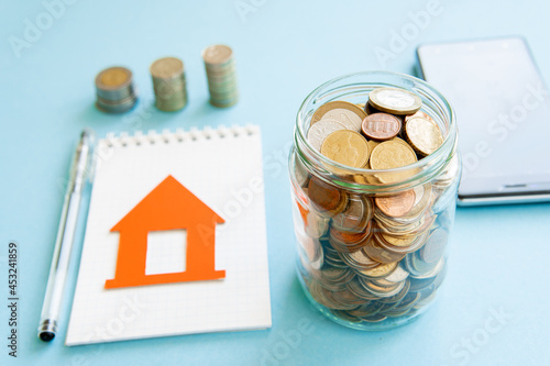 The coins are stored in a glass jar to accumulate finances.