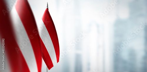 Obraz na płótnie Small flags of Austria on the background of a blurred background