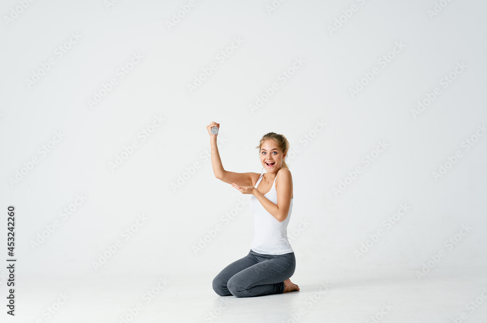 athletic woman sitting on the floor exercise dumbbells fitness athletic woman sitting on the floor exercise dumbbells fitness
