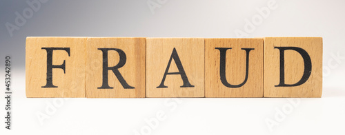 The word Fraud was created from wooden cubes. finance and economy.