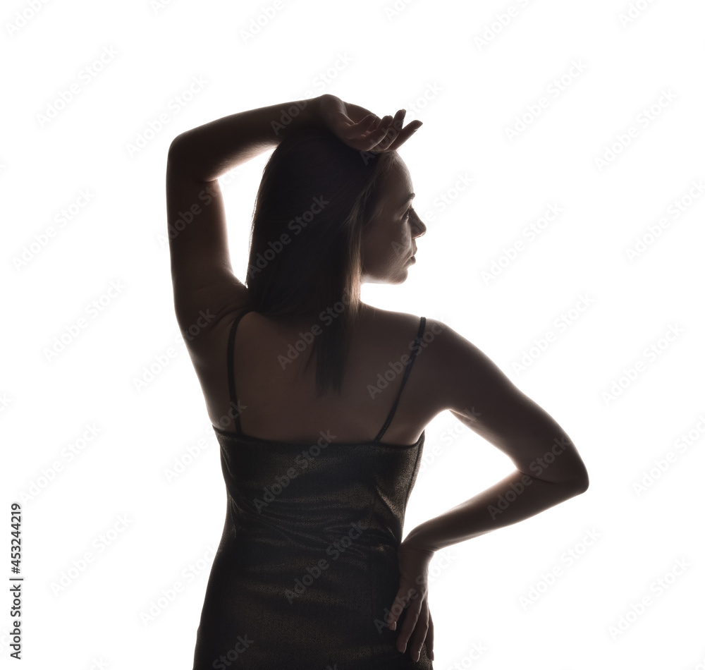 Fototapeta premium Silhouette of stylish young woman on white background
