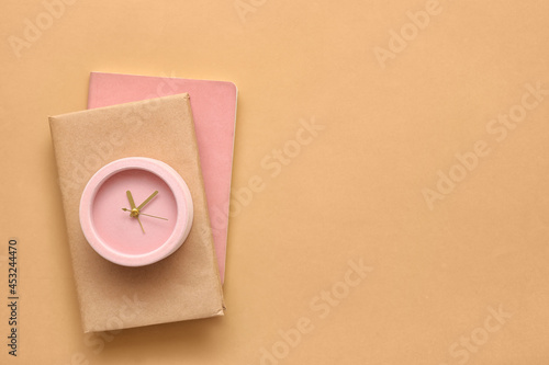 Pink alarm clock on brown a...