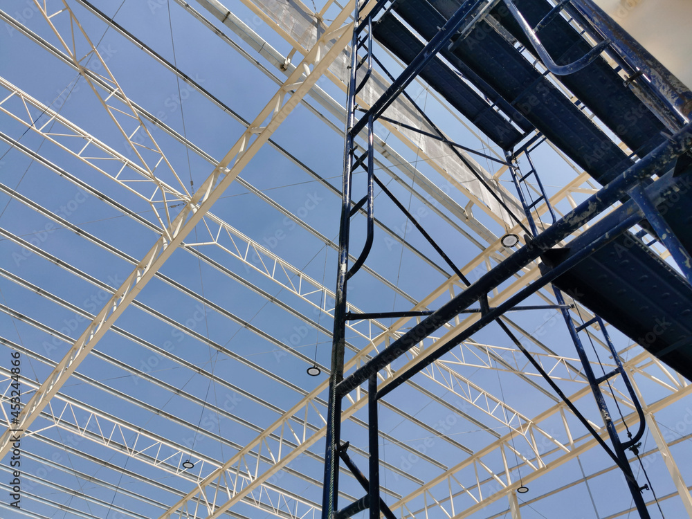 blue scaffolding is setting in construction site, main trusses and sub trusses before install roof sheet, blue scaffolding is setting in construction site, main trusses and sub trusses before install roof sheet,