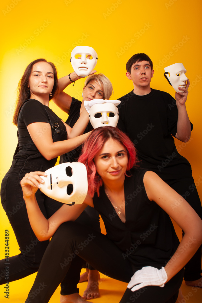 girls in white masks and white gloves in the image of mimes an unseen wall show hands actors of theater and cinema, the concept of advertising a shopping center girls in white masks and white gloves in the image of mimes an unseen wall show hands actors of theater and cinema, the concept of advertising a shopping center