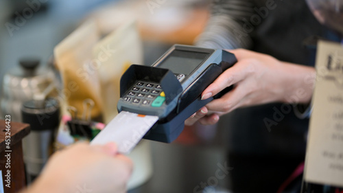 Closeup image of customer insert credit card in payment machine