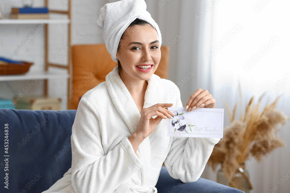 Young woman with gift certificate for massage at home Young woman with gift certificate for massage at home