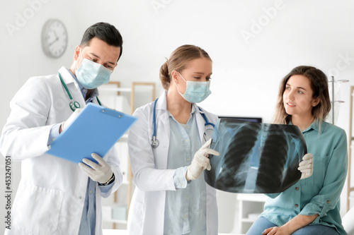 Young doctor showing x-ray ...