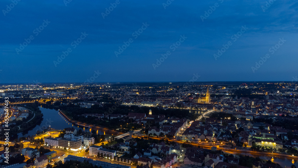 Aerial view of world famous skyline of Regensburg in Bavaria, Germany with cathedral and old town at night