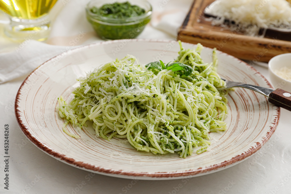 Plate with tasty pesto pasta on light background, closeup Plate with tasty pesto pasta on light background, closeup