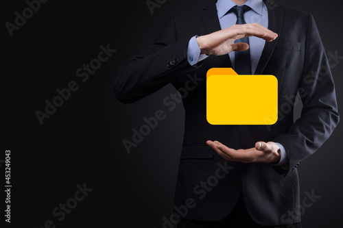 Fototapeta Naklejka Na Ścianę i Meble -  Businessman hold folder icon.Document Management System or DMS setup by IT consultant with modern computer are searching managing information and corporate files.Business processing,