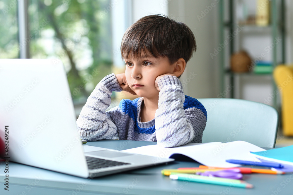 Little boy tired of studying online at home Little boy tired of studying online at home