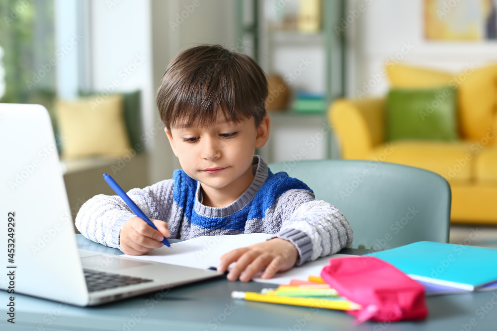 Little boy studying online at home Little boy studying online at home