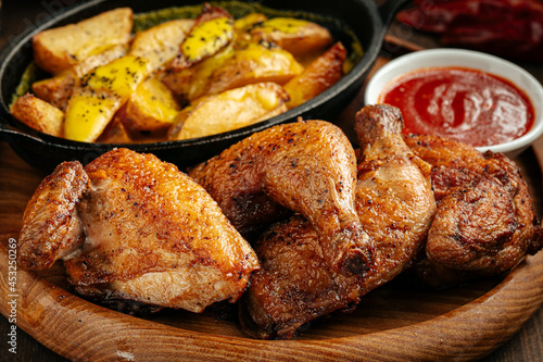Rustic roasted chicken with potatoes and red sauce