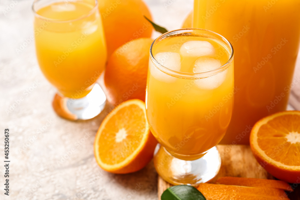 Glasses of tasty orange juice on light background, closeup Glasses of tasty orange juice on light background, closeup