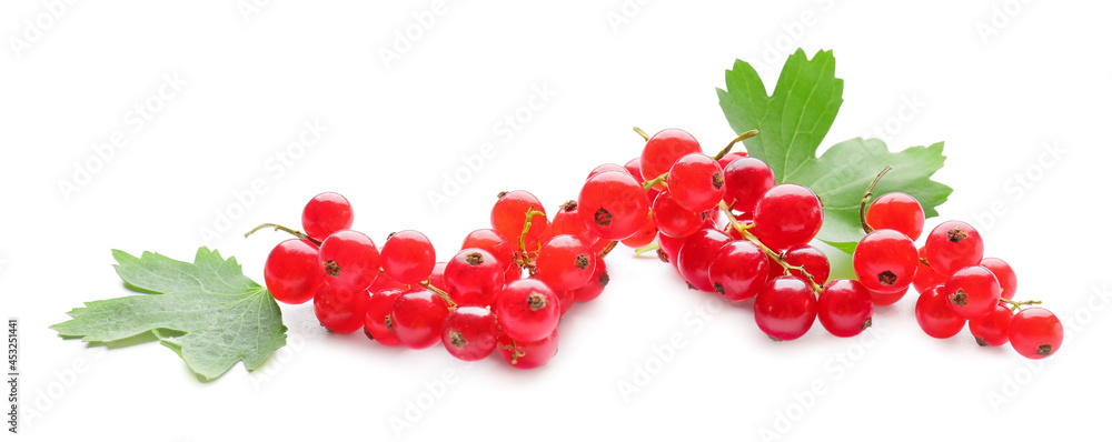 Fresh red currants and leaves on white background