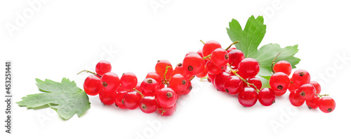 Fresh red currants and leaves on white background