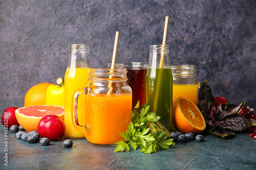 Fototapeta Naklejka Na Ścianę i Meble -  Bottles with healthy juice, fruits and vegetables on dark background