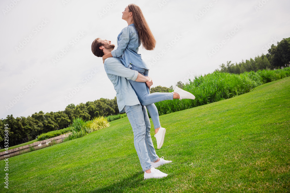 Full size profile side good mood smiling couple dancing husband hold wife spinning around have romantic date in park Full size profile side good mood smiling couple dancing husband hold wife spinning around have romantic date in park
