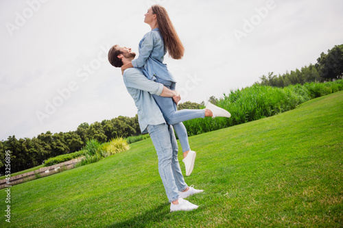 Full size profile side good mood smiling couple dancing husband hold wife spinning around have romantic date in park