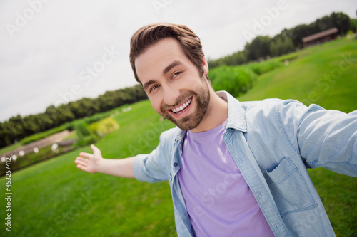 Portrait of young attractive handsome positive guy take selfie traveling blogging recording show demonstrate beautiful nature