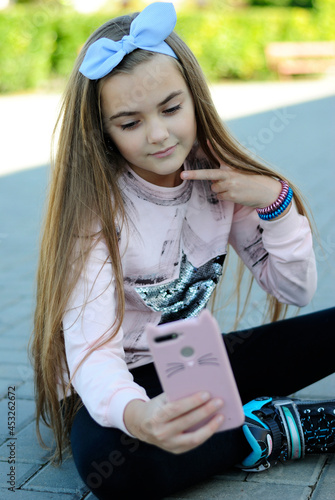 beautiful teenage girl with long hair wearing blue glasses and a plaid shirt portrait