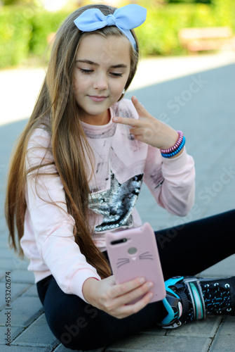 beautiful teenage girl with long hair wearing blue glasses and a plaid shirt portrait