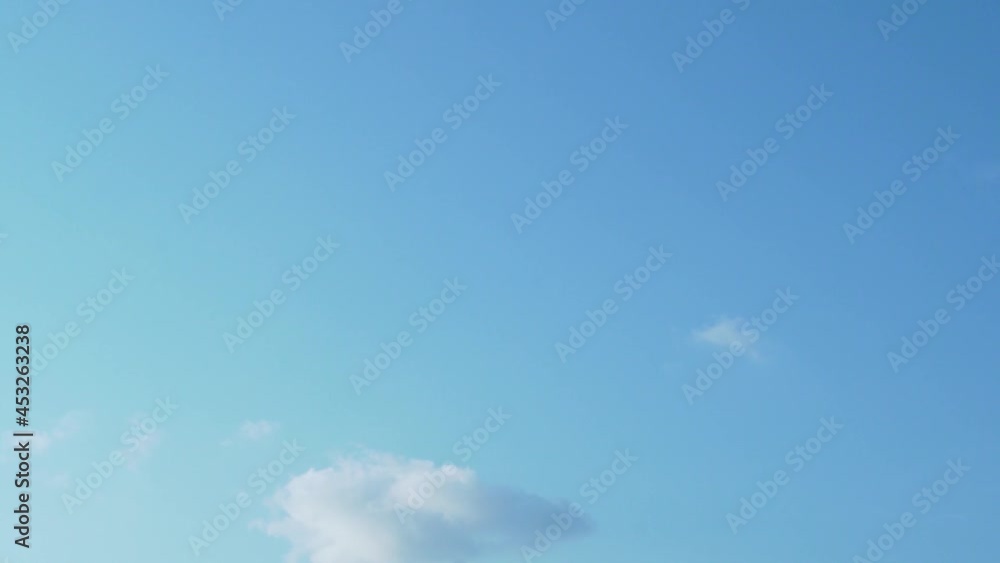 Light Clouds in a Clear Azure Sky, Timelapse. The background consists of a Serene Heavenly Blue Sky and a Small White Cloud. Air, Atmosphere, Ozone Layer, Climate. Sunny Day, Nature 4K. Light Clouds in a Clear Azure Sky, Timelapse. The background consists of a Serene Heavenly Blue Sky and a Small White Cloud. Air, Atmosphere, Ozone Layer, Climate. Sunny Day, Nature 4K.