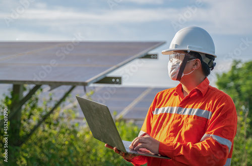 Photovoltaic Engineer or electrician working with laptop computer
