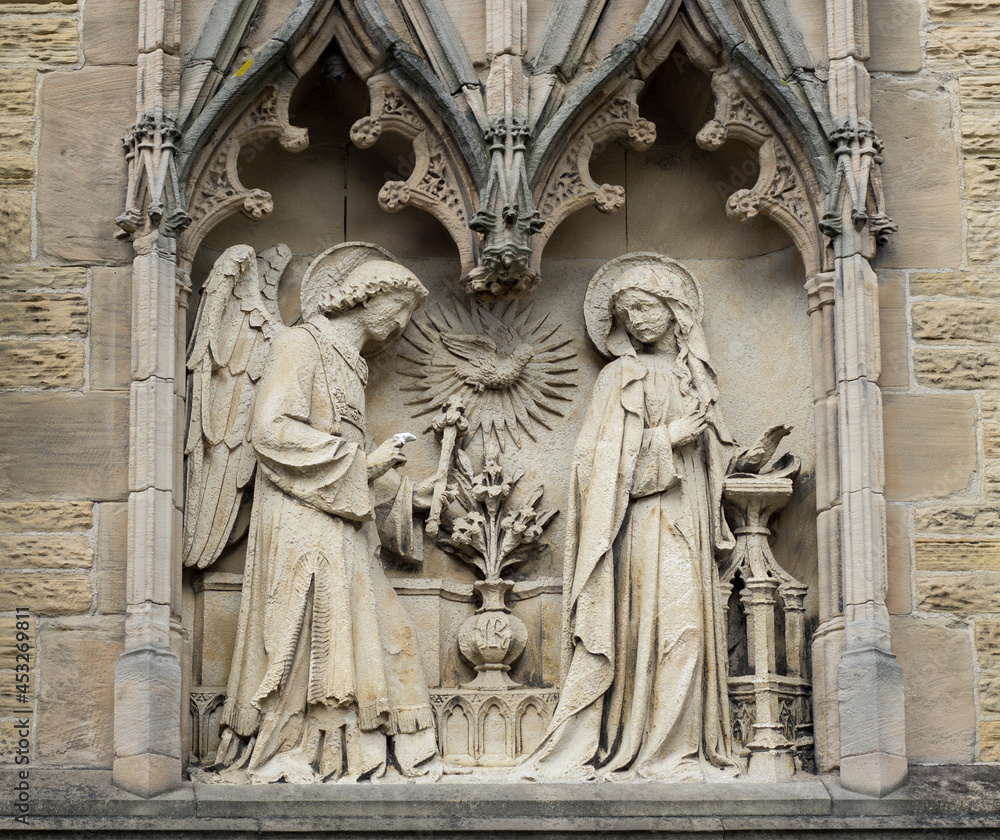 A Textured Stone Wall Sculptured Art Of Angel Gabriel Visiting Mother Mary.