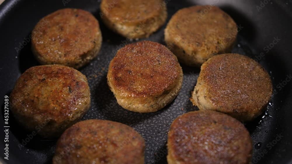 Frying meatballs in frying pan sizzling in hot oil. The focus is one cutlet. Frying meatballs in frying pan sizzling in hot oil. The focus is one cutlet.
