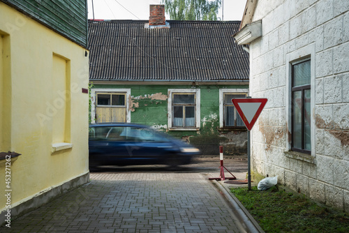 Car on narrow street.