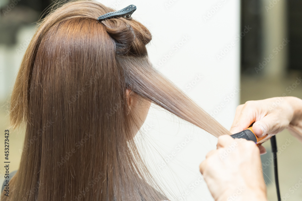 ヘアアイロンを使ってセットするスタイリスト ヘアアイロンを使ってセットするスタイリスト