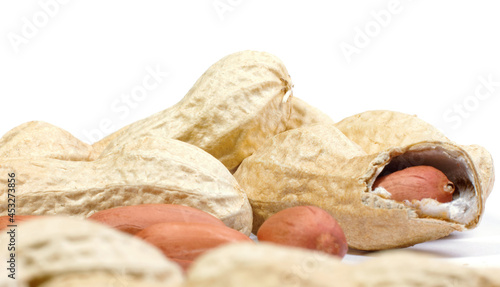 Peanuts in shell and peeled on a white background.