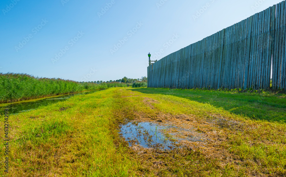 Unesco protected outline of an ancient former harbor of an island swallowed by reclaimed new land under a blue sky in summer, Noordoostpolder, Schokland, Flevoland, Netherlands, August 23, 2021 Unesco protected outline of an ancient former harbor of an island swallowed by reclaimed new land under a blue sky in summer, Noordoostpolder, Schokland, Flevoland, Netherlands, August 23, 2021