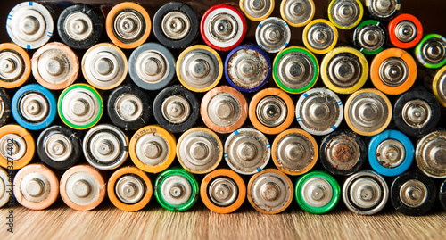 Discharged batteries placed neatly on a table.