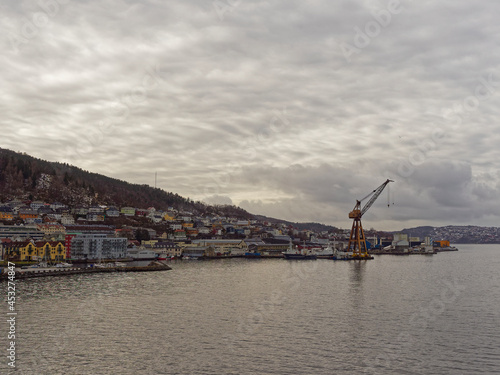 Apartments, Houses and Maritime Buildings all mixed up with one another on the waterfront of Bergen Port under a winters sky. © Julian