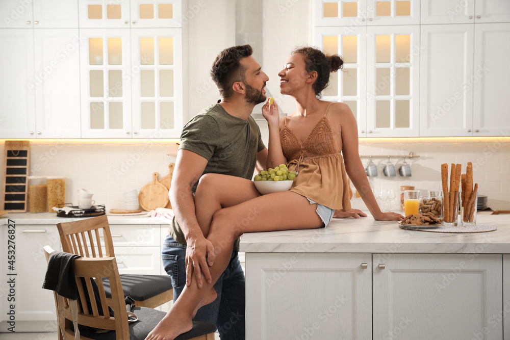 Lovely couple enjoying time together in kitchen at home Lovely couple enjoying time together in kitchen at home