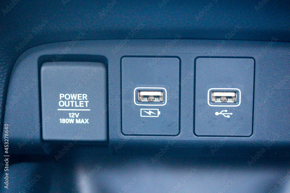 Various power and USB ports in the dashboard of a modern vehicle Various power and USB ports in the dashboard of a modern vehicle