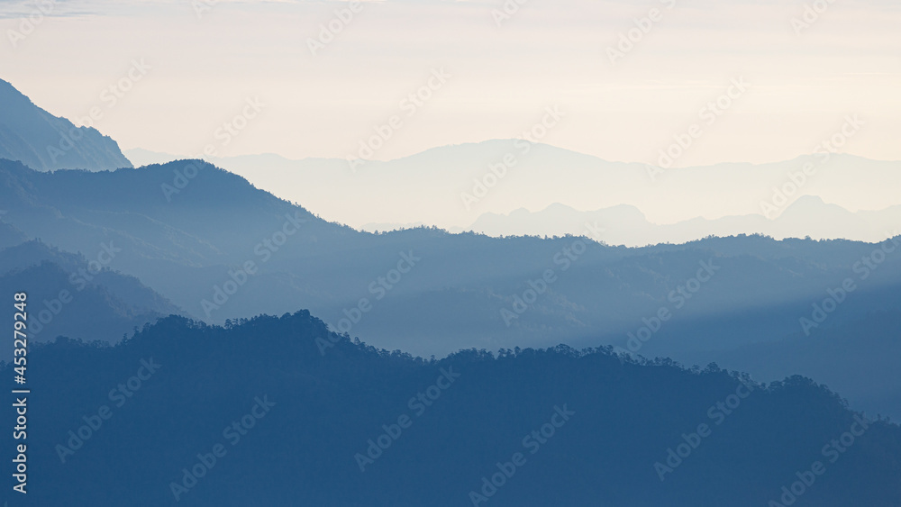 Natural scene of blue mountain range covered by mist and fog. Natural scene of blue mountain range covered by mist and fog.
