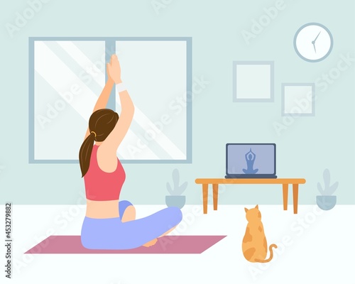 Woman doing yoga at home with an online yoga tutorial.