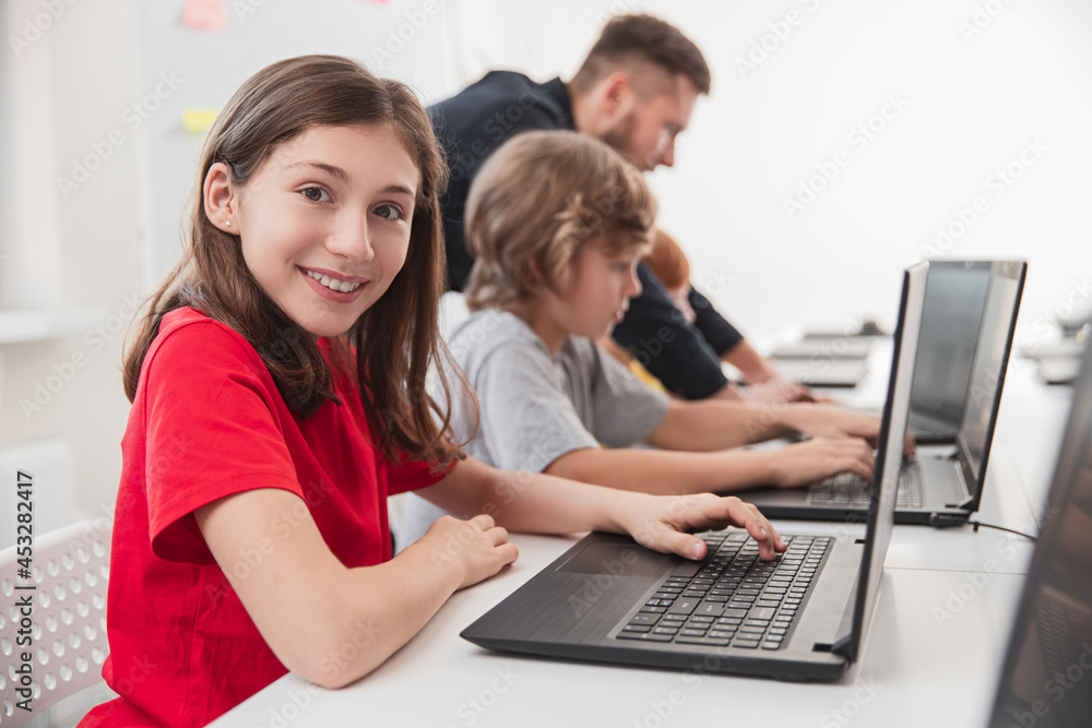 Smart kids studying programming in classroom Smart kids studying programming in classroom