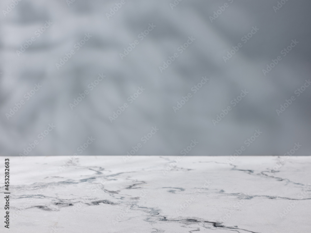Marble table on the background of a concrete wall. Mockup for product presentation
