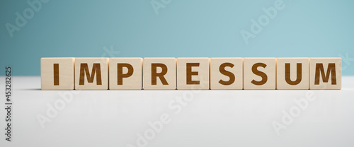 Tableau sur toile "Impressum" web banner - the German word Impressum built from letters on wooden cubes for the use as a web banner