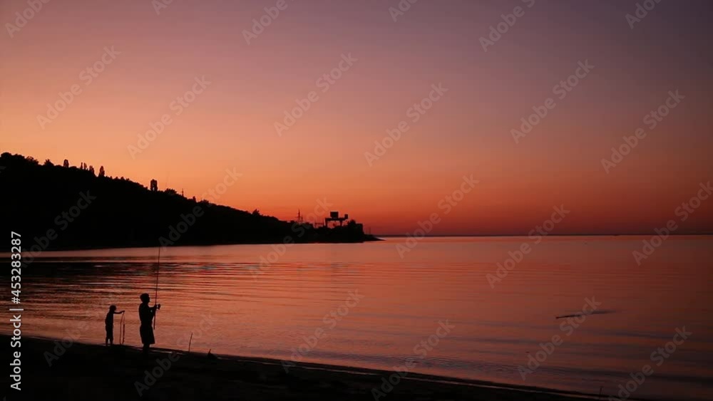 happy family is fishing at the sunset; happy family weekend happy family is fishing at the sunset; happy family weekend